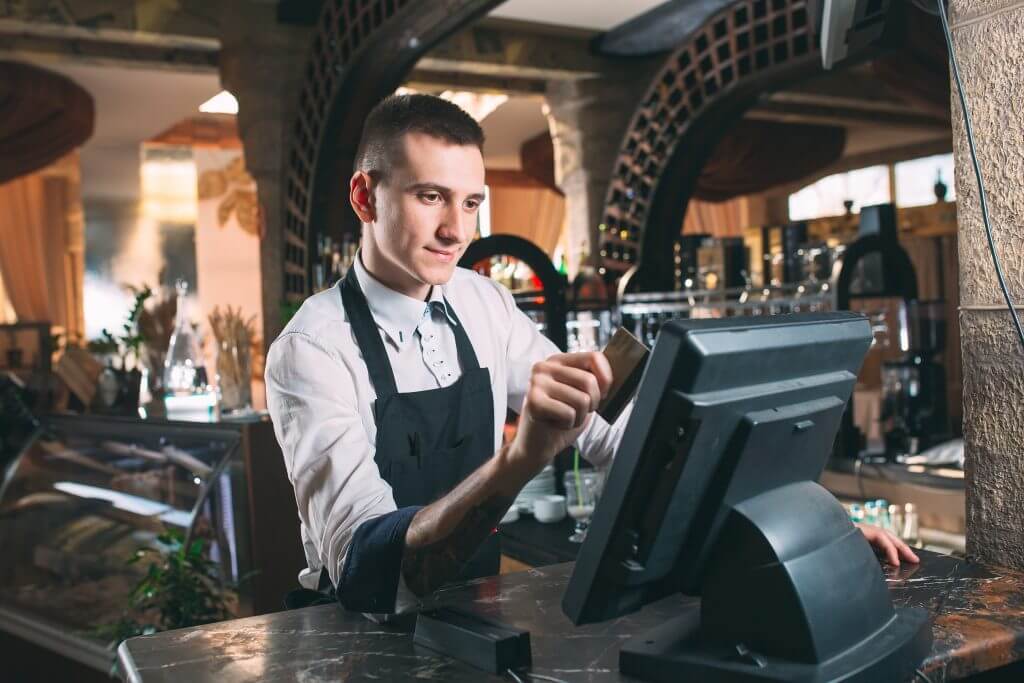 waiter-using-point-of-sale-in-restaurant-setting