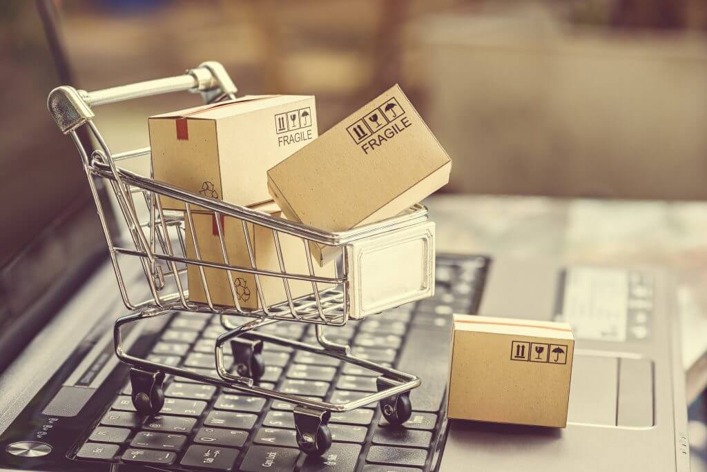 shoping-cart-filled-with-box-on-top-of-computer-keyboard